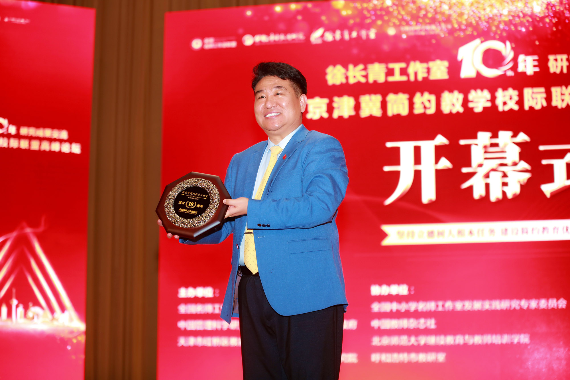 北京中教市培教育研究院顧問(wèn)徐安德祝賀徐長(zhǎng)青工作室成立十周年，并贈(zèng)送紀(jì)念品。